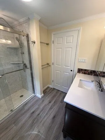Glass shower with a grab bar mounted on the tile wall