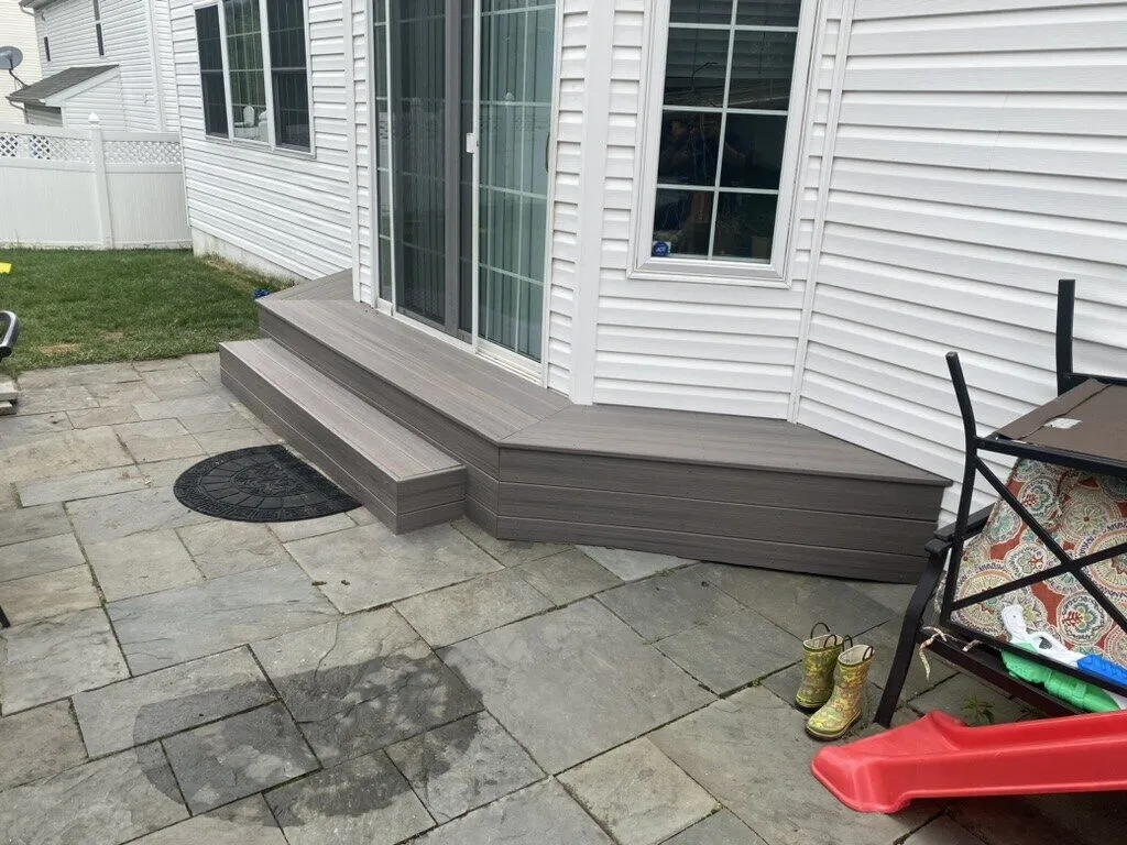 New steps leading from a sliding door down to a stone patio