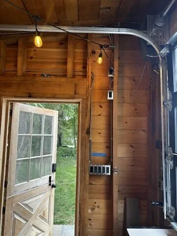 White dutch door with window panes set in a wood-panelled wall