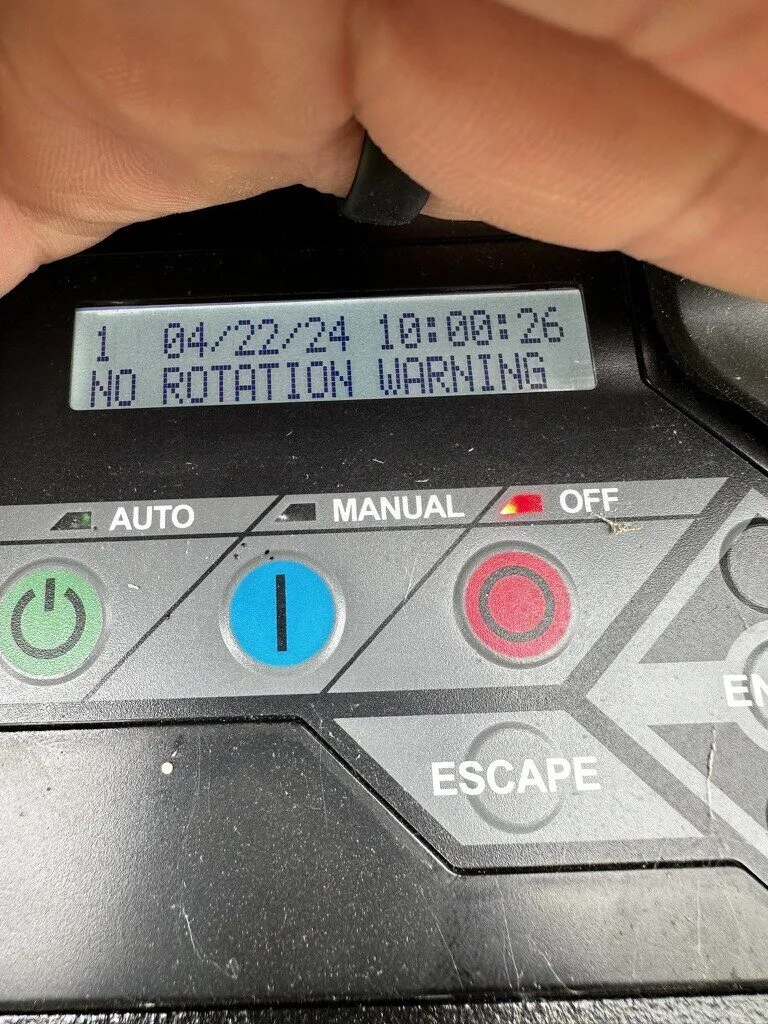 Generac controller display showing a status message with Auto, Manual and Off buttons
