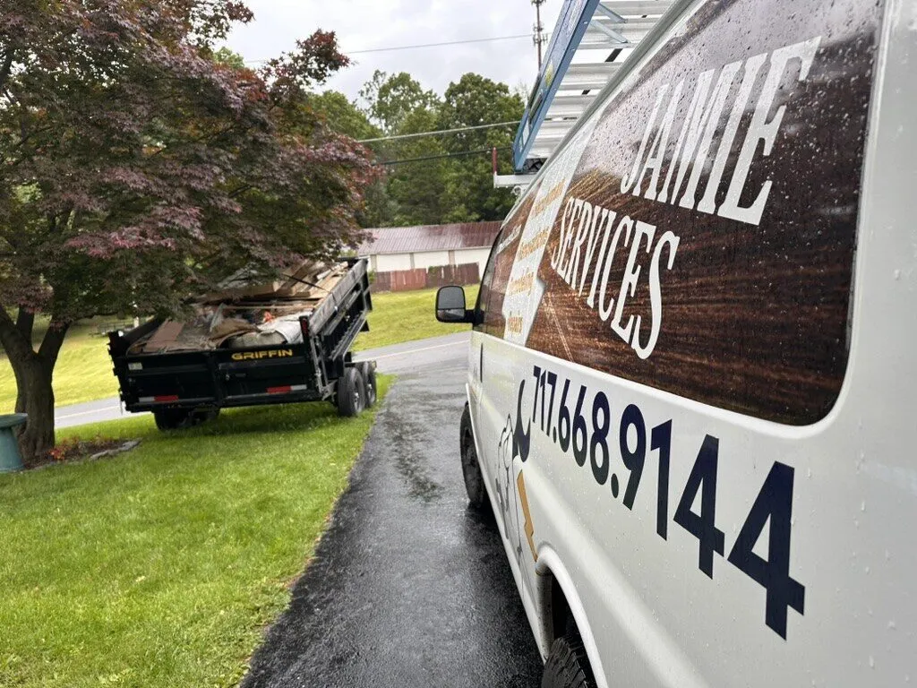 Jamie Services van with the company name and phone number on the side